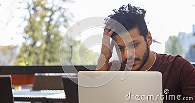 Portrait of young, hopeful Asian man in work. Young businesssman is working in a cafeteria. Business From coffee shop Stock Photo