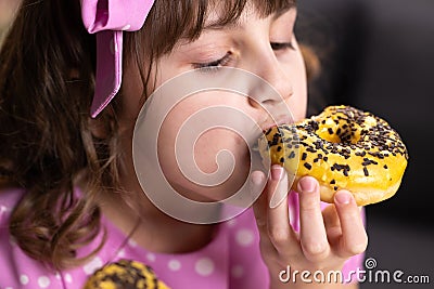 Portrait of young hungry girl eating donut. Female mouth bites a loaf. Close-up woman eating donut , delicious, sweet Stock Photo