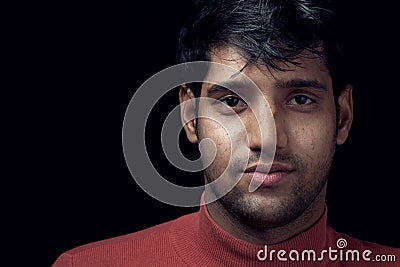 Portrait of young Indian man over dark Stock Photo