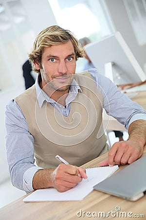 Portrait of young instructor in business class evaluating Stock Photo