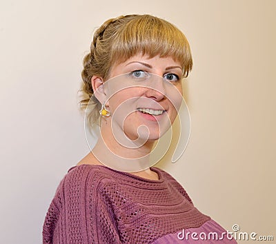 Portrait of the young joyful woman with amber earrings Stock Photo