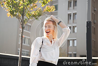 Portrait of young laughing woman in modern clothes fooling around trying on new look. Stock Photo