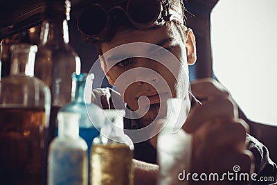 Portrait of a young mad scientist dressed in steampunk style and Stock Photo