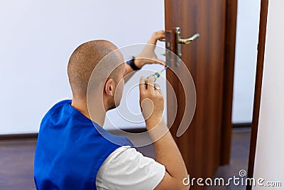 Portrait Young Male Carpenter Repairing Door Lock Stock Photo