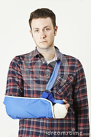 Portrait Of Young Man With Arm In Sling Stock Photo