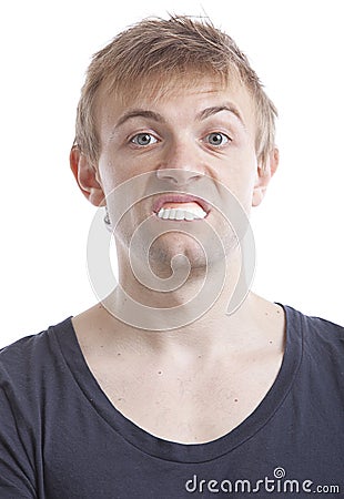 Portrait of young man with fake teeth against white background Stock Photo
