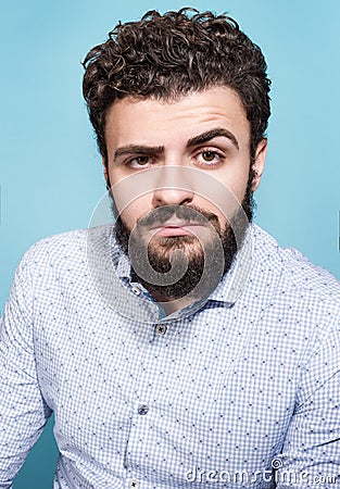 Portrait of a young man with the gaze on a blue background. Stylish appearance Stock Photo