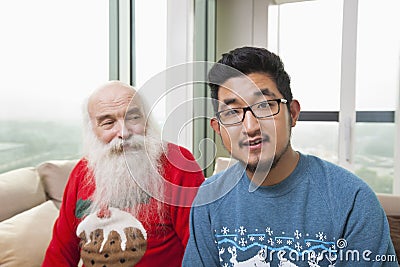 Portrait of young man with grandfather looking at him Stock Photo