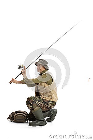 Portrait of young man, professional fishman with fishing rod, spinning and equipment going to river isolated over white Stock Photo