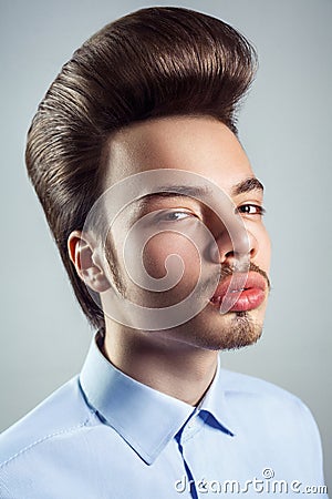 Portrait of young man with retro classic pompadour hairstyle. Stock Photo