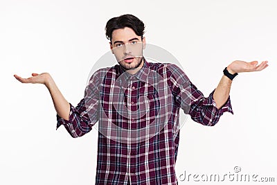 Portrait of a young man shrugging shoulders Stock Photo