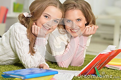 Portrait of a mother helps with homework Stock Photo