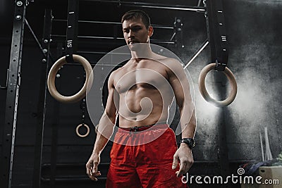 Portrait of young muscular crossfit athlete preparing for workout at the gym Stock Photo