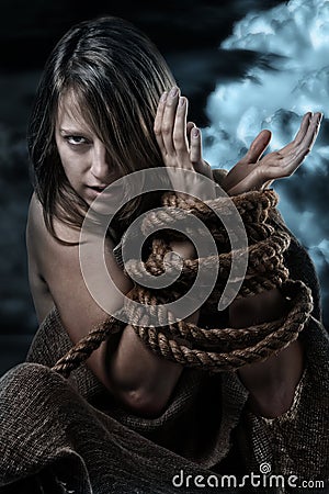 Wild woman with tied up hands Stock Photo