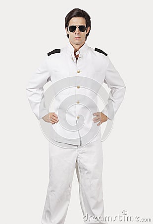 Portrait of young navy officer standing against gray background Stock Photo