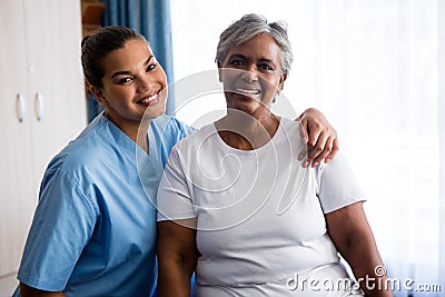 Portrait of young nurse with patient in nursing home Stock Photo