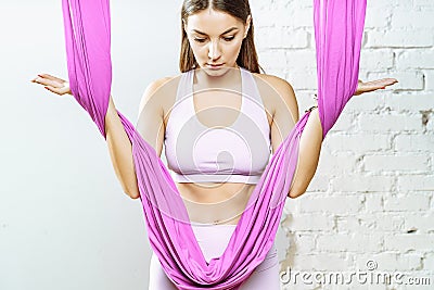 Portrait of a young pacified woman with a purple hammock on white background Stock Photo