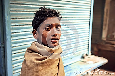 Portrait of young poor homeless man on abandoned street of indian city Editorial Stock Photo