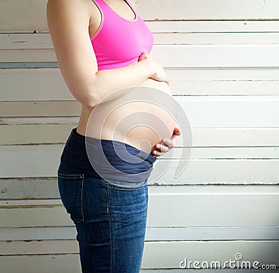 Portrait of a young pregnant woman holding stomach Stock Photo