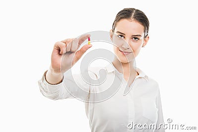 Young pretty business woman showing a two color pill Stock Photo