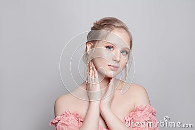Portrait of young pretty gentle blonde woman with updo hairdo on white background Stock Photo