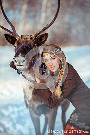 Portrait of a young pretty girl with a reindeer Stock Photo