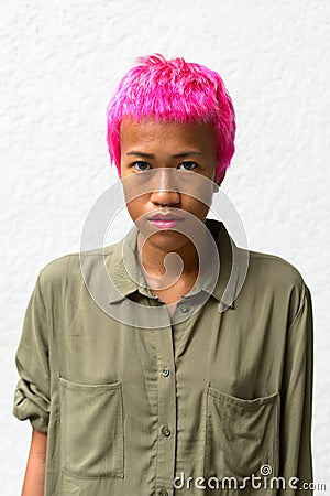 Young rebellious Asian woman with pink hair Stock Photo