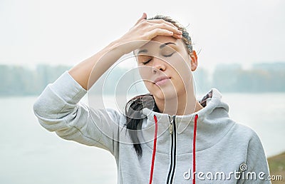 Portrait of a young sad woman with headache, fatigue or cold. D Stock Photo