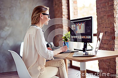 Portrait of young satisfied smiling woman sitting at the table a Stock Photo