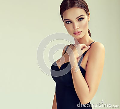 Portrait of young, sexual woman dressed in seductive black body. Makeup and cosmetology. Stock Photo