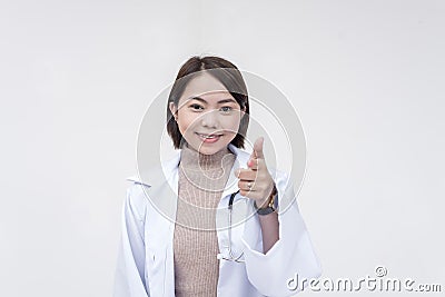 Portrait of a young and skilled doctor, medical student, intern, posing while pointing at the camera. on a white Stock Photo