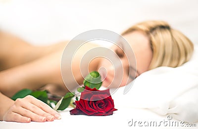 Portrait of young sleeping woman with rose Stock Photo