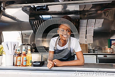 Portrait of young small business owner standing in her food truck waiting for clients Stock Photo