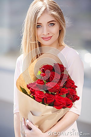 Portrait Of Young Smiling Beautiful Woman with flowers Stock Photo