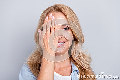 Portrait of young smiling good mood female cover close half face eyesight vision isolated on grey color background Stock Photo