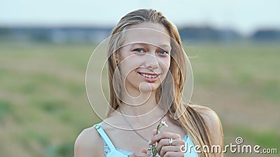 Portrait of a Young Smiling Sixteen-year-old Girl with a Daisy Flower in Her Hands. Blonde with Long Hair. Stock Video - Video of idea, dentistry: 126214103 