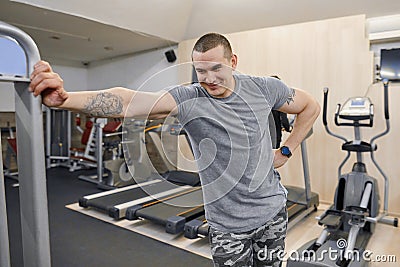 Portrait of young smiling strong muscular man in the gym Stock Photo