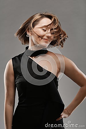 Portrait of young smiling woman in black dress Stock Photo