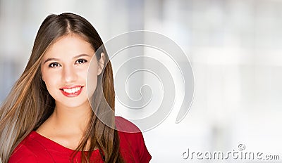 Portrait of a young smiling woman. Bright copy-space on the right Stock Photo