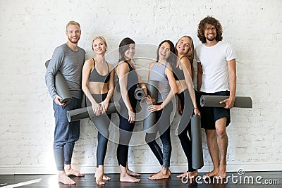 Group of young sporty people standing at the wall Stock Photo