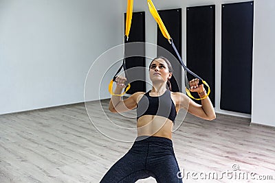 Portrait of young strong athletic woman in black sportswear doing push ups training upper body chest shoulders pecs triceps, Stock Photo