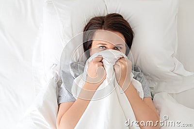 Portrait of young surprised woman in bed Stock Photo