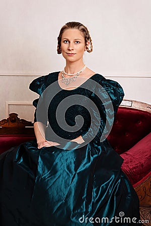 Portrait young victorian woman in green dress Stock Photo