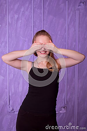 Portrait of young woman in a black closed her eyes with her hand Stock Photo