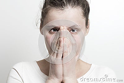 Portrait of young woman covering her face by hands. On face is e Stock Photo
