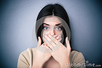 Portrait of a young woman covering her mouth Stock Photo