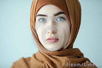 portrait of a young woman eastern type in the modern Muslim clothes and beautiful headdress Stock Photo