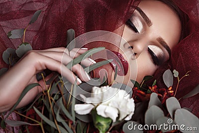 Portrait of young woman with fashionable makeup and eucalyptus b Stock Photo
