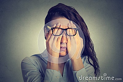 Portrait young woman in glasses covering face eyes using her both hands Stock Photo