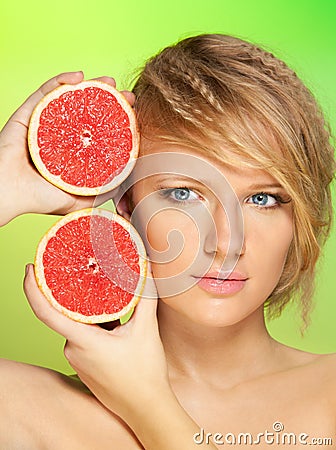 Portrait of young woman with grapefruit Stock Photo